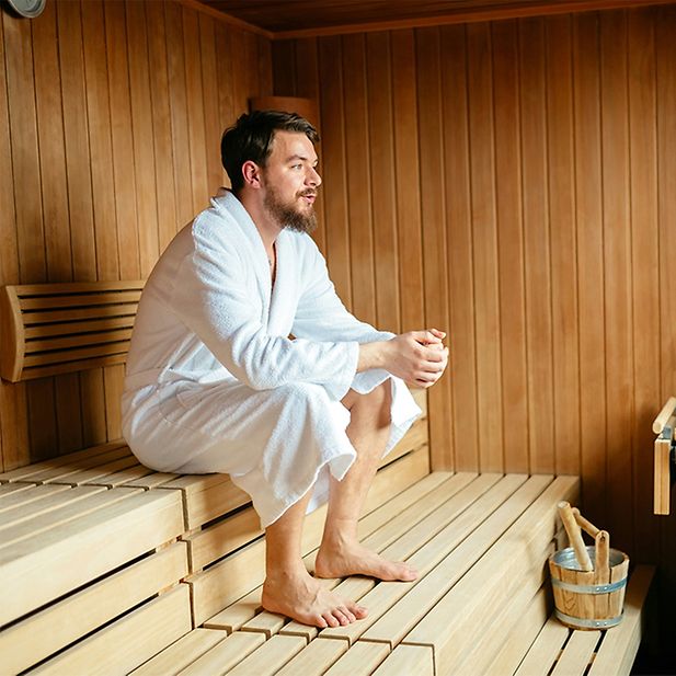 Man sits in sauna 